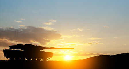 Silhouette of army tank at sunset sky background. Military machinery.