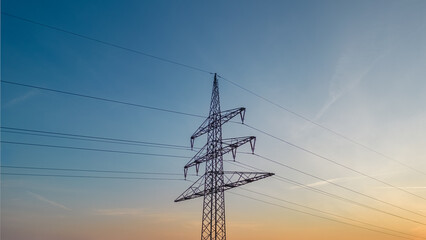 power pylon and power lines against the evening sky