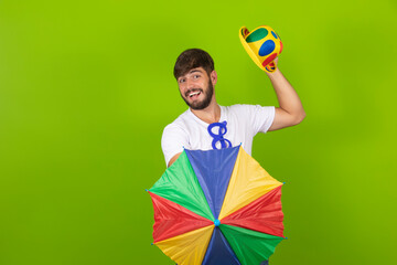 Young handsome boy dressed for carnival holding a frevo umbrella