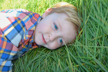 Toddler, boy, child, caucasion, white, blue eyes, grass, playing, smiling, curious, blue sky, running, check shirt