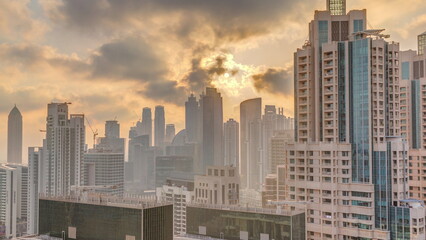 Fototapeta na wymiar Dubai skyscrapers with golden sunset over business bay district .