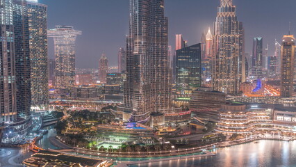 Naklejka na ściany i meble Aerial view of Dubai city day to night in downtown.