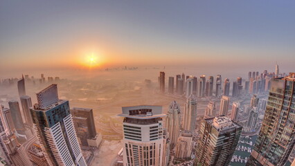 Panorama of Dubai Marina with JLT skyscrapers and golf course during sunrise , Dubai, United Arab Emirates.