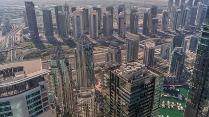 Fototapeta na wymiar JLT and Dubai Marina skyscrapers intersected by Sheikh Zayed Road all day