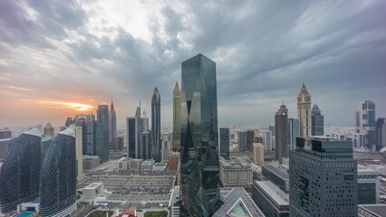 Panorama of futuristic skyscrapers with sunset in financial district business center in Dubai on Sheikh Zayed road