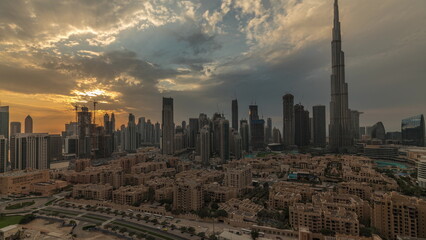Fototapeta na wymiar Sunset over Dubai Downtown with tallest skyscraper and other towers