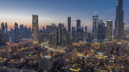 Dubai's business bay towers aerial day to night . Rooftop view of some skyscrapers