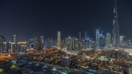 Fototapeta na wymiar Panorama showing Dubai Downtown and business bay night with tallest skyscraper and other towers