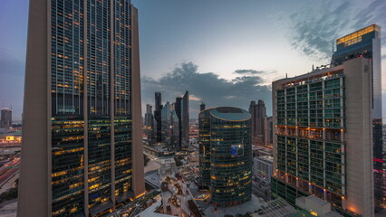 Dubai international financial center skyscrapers aerial day to night .