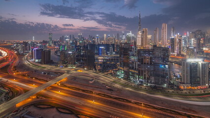 Naklejka na ściany i meble Skyline with modern architecture of Dubai business bay towers day to night . Aerial view