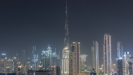Panoramic skyline of Dubai with business bay and downtown district night .