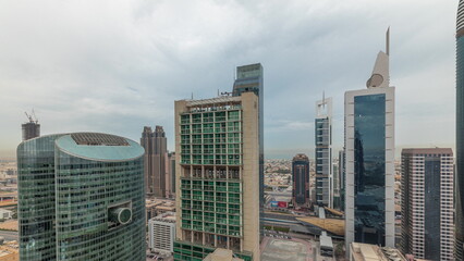 Fototapeta premium Panorama showing Dubai international financial center skyscrapers with promenade on a gate avenue aerial .