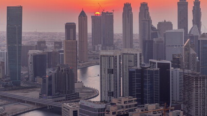 Skyline with modern architecture of Dubai business bay towers at sunset . Aerial view