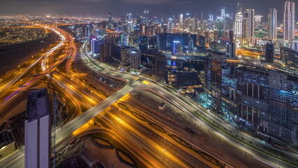 Panorama showing skyline of Dubai with business bay and downtown district night .