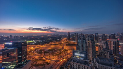 Fototapeta premium Huge highway crossroad junction between JLT district and Dubai Marina night to day .
