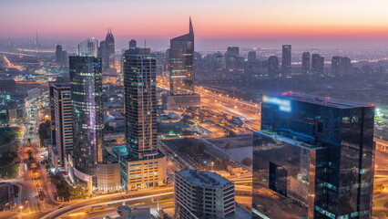 Aerial view of media city and al barsha heights district area night to day from Dubai marina.