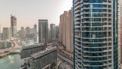 Panorama showing overview to JBR and Dubai Marina skyline with modern high rise skyscrapers waterfront living apartments aerial