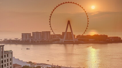 Obraz premium Sunset over Bluewaters island with modern architecture and ferris wheel aerial .