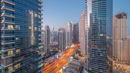 Fototapeta na wymiar View of the Dubai Marina and JBR area and the famous Ferris Wheel aerial night to day