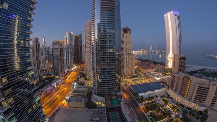 Fototapeta na wymiar Panoramic view of the Dubai Marina and JBR area and the famous Ferris Wheel aerial night to day