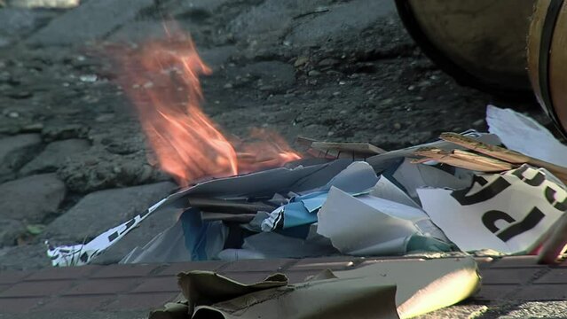 Preparing Drums by Heating the Skins by a Fire, Drummers Tune their Drums by the Heat of Fire on a Street in Buenos Aires, Argentina. Close Up.