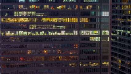 Windows of office buildings night to day , the light from the windows of houses