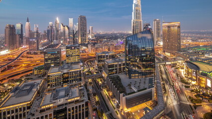 Obraz premium Futuristic Dubai Downtown and finansial district skyline aerial day to night .