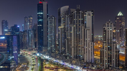 Obraz na płótnie Canvas Bay Avenue with modern towers residential development in Business Bay aerial all night , Dubai