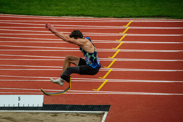 male paraathlete long jump in competition