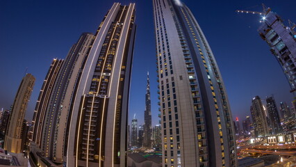 Panorama of tallest skyscrapers in downtown dubai located on bouleward street near shopping mall aerial day to night .