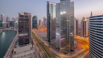 Obraz premium Cityscape of skyscrapers in Dubai Business Bay with water canal aerial night to day