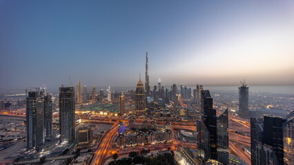 Fototapeta na wymiar Aerial panorama view of tallest towers in Dubai Downtown skyline and highway day to night .