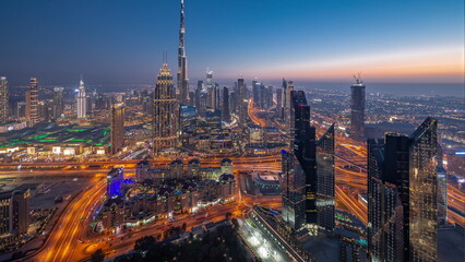 Fototapeta na wymiar Aerial view of tallest towers in Dubai Downtown skyline and highway day to night .