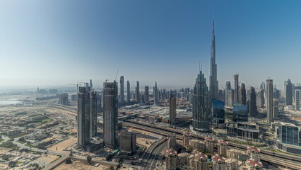 Fototapeta na wymiar Panorama showing aerial view of tallest towers in Dubai Downtown skyline and highway .