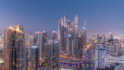 Obraz premium View of various skyscrapers in tallest recidential block in Dubai Marina aerial day to night