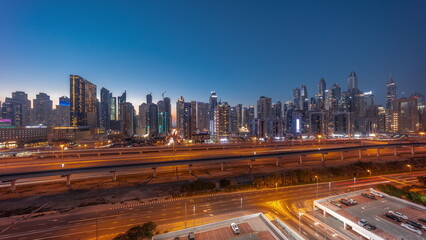 Obraz premium Dubai marina tallest block of skyscrapers day to night .