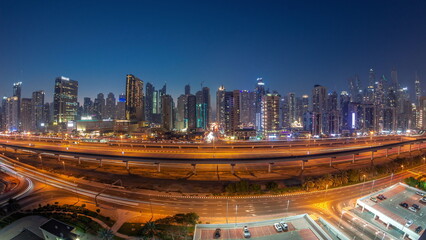 Fototapeta na wymiar Panorama of Dubai Marina skyscrapers and Sheikh Zayed road with metro railway aerial day to night , United Arab Emirates