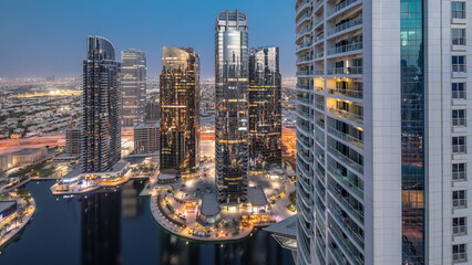 Fototapeta na wymiar Tall residential buildings at JLT aerial day to night , part of the Dubai multi commodities centre mixed-use district.