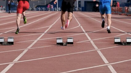 slow motion start male athletes run sprint race - Powered by Adobe