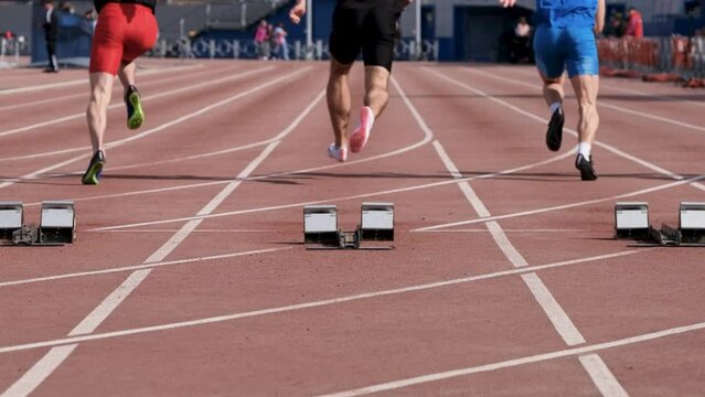 slow motion start male athletes run sprint race