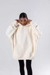 Attractive african american woman in oversized white hoodie. Mock-up.