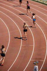group female athletes start running 400 meters