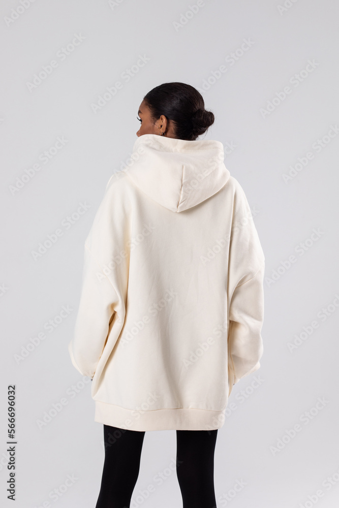 Wall mural Attractive african american woman in oversized white hoodie. Mock-up.