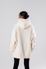 Attractive african american woman in oversized white hoodie. Mock-up.