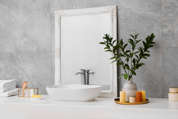 Naklejka na ściany i meble Beautiful plant in vase and burning candles near vessel sink and mirror on bathroom vanity