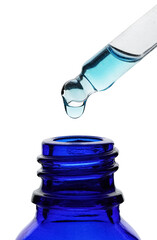 Dripping light blue facial serum from pipette into glass bottle on white background, closeup