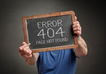 Page not found 404 error - white chalk text on a slate blackboard held by a person, HTTP status code