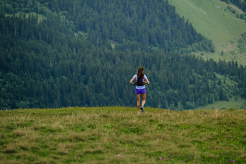 female trail runner running ultramarathon race