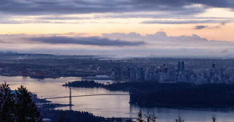 Fototapeta na wymiar Urban Downtown City and Stanley Park in Vancouver, British Columbia, Canada. Winter Sunrise.