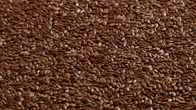 linseeds seeds close-up. unroasted nuts rotate and zoom. natural vegan food. walnut background. High quality 4k footage